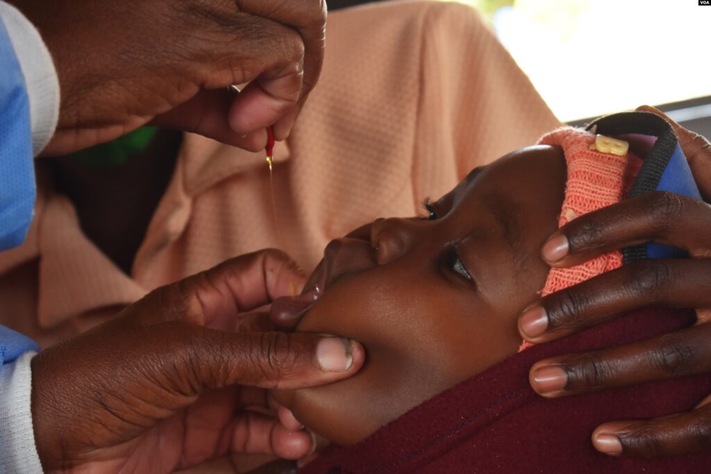 A baby receives a vitamin A supplement as part of efforts to ensure that children are healthy and do not succumb to diseases. (Columbus Mavhunga/VOA)